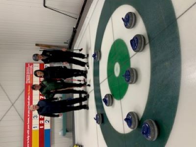 ECC curlers celebrating an eight-ender