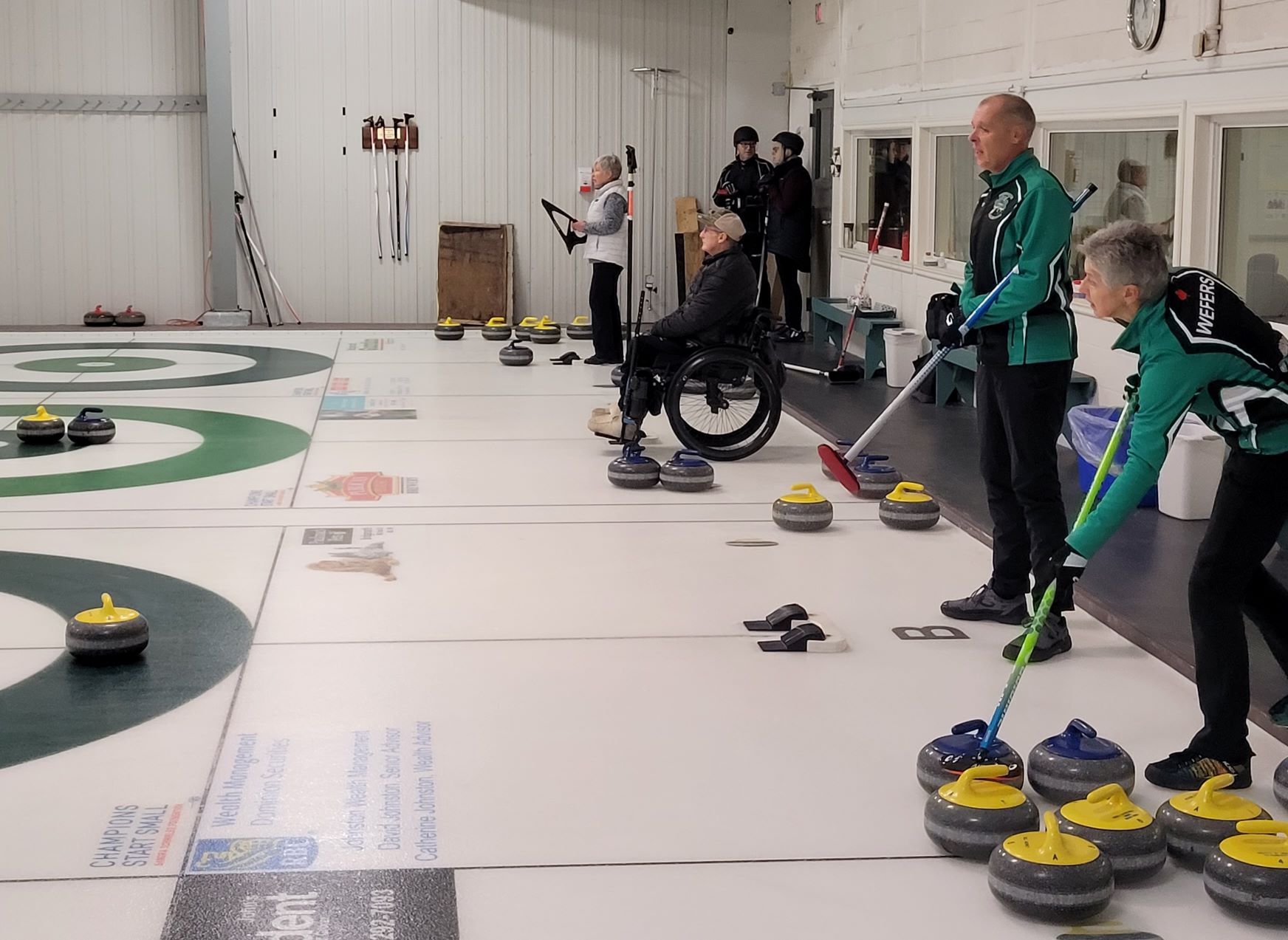 A wheelchair curler and teammates playing a game at ECC